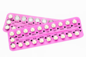 Pink oral contraceptive pill strips isolated on white background with clipping path.